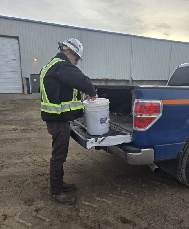 Angela Vande engineer in blue coveralls hard hat field